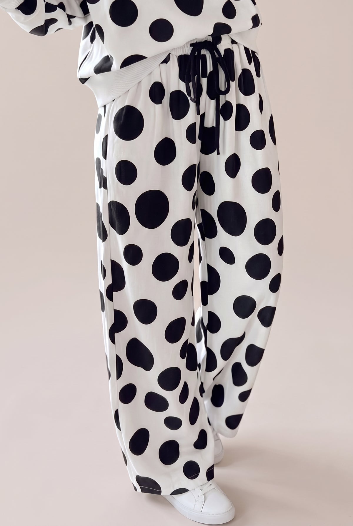Black and white polka dot wide-leg pants with a drawstring waist