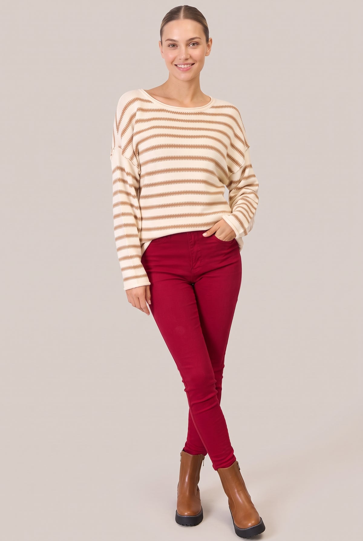 Full-length front view of a cream sweater with camel stripes and dropped shoulders