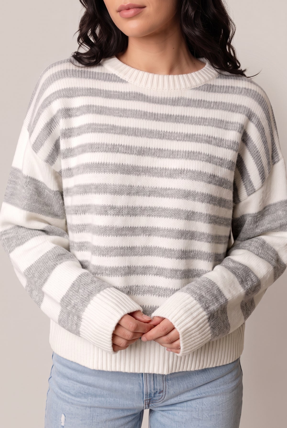Close front view of the striped sweater showing the ribbed crew neck, ribbed cuffs and ribbed hem