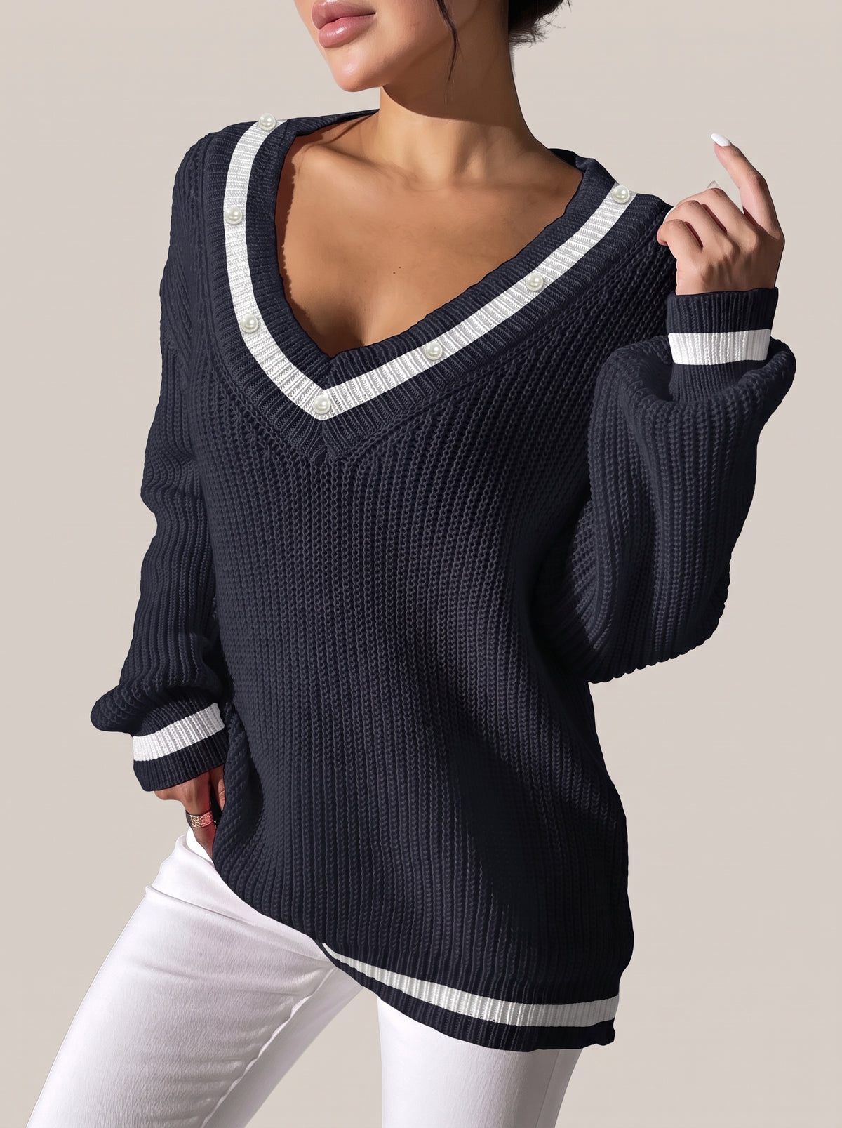 Dark navy V-neck rib-knit sweater with white contrast trim and pearl-look beads along the neckline, front view