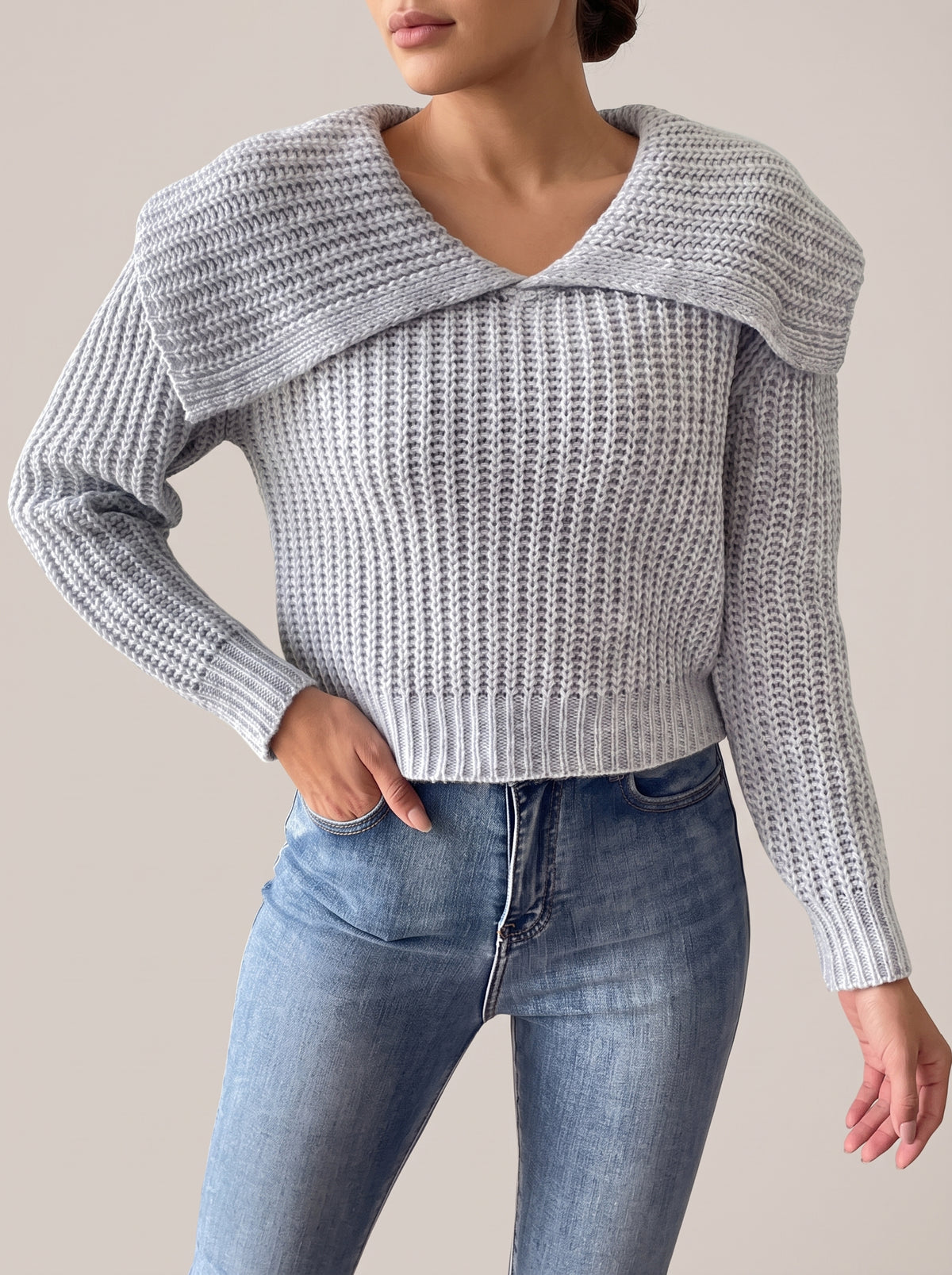 Gray rib-knit cropped sweater with a wide fold-over collar and V-neckline, front view