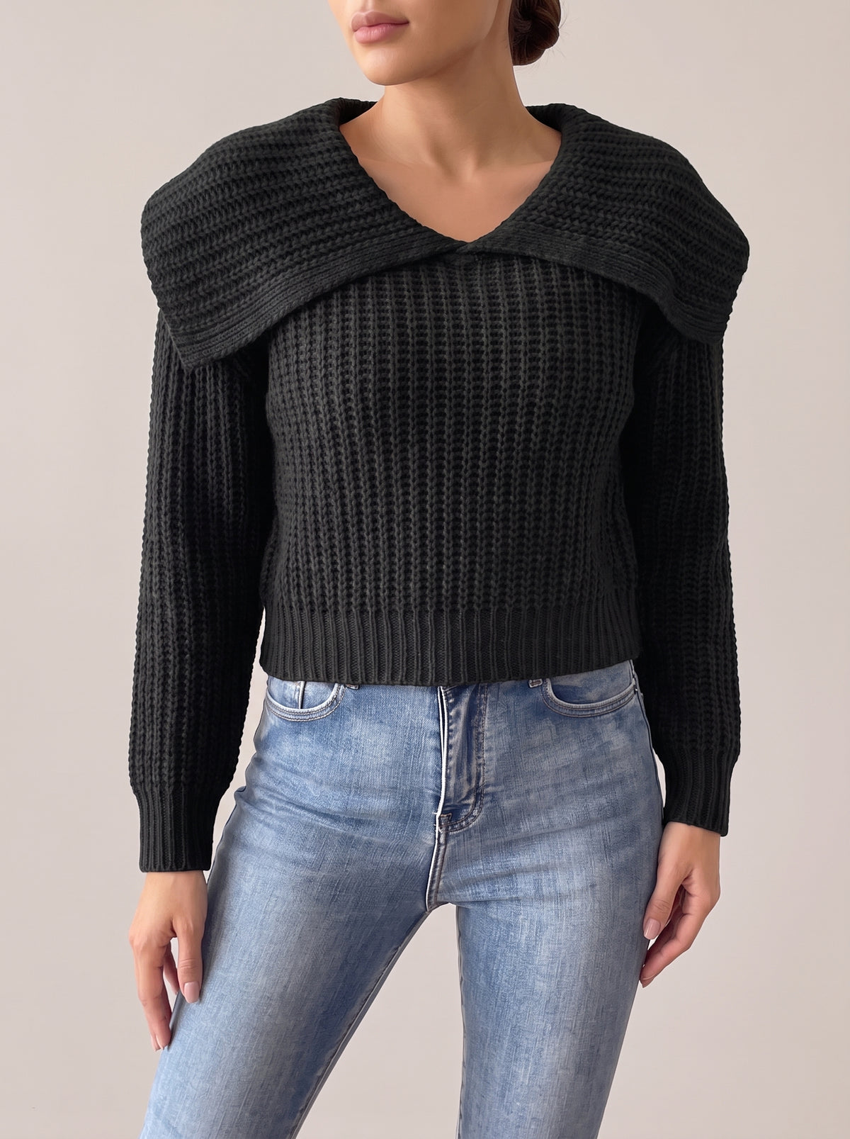 Black rib-knit cropped sweater with a wide fold-over collar and V-neckline, front view